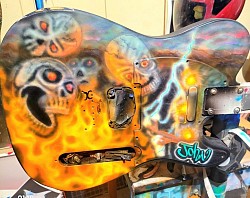 Skull fire mini explosions airbrushed custom guitar by Elite Paintworx By Moore